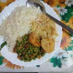 A picture of Rice,peas,potato and vegies.
