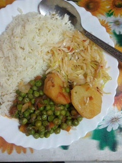 A picture of Rice,peas,potato and vegies.