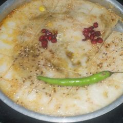 A picture of White dhokla stuffing with corn and spinach.