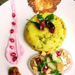 A picture of Masala khichdi with pomegranate raita.