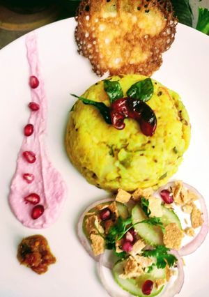 A picture of Masala khichdi with pomegranate raita.