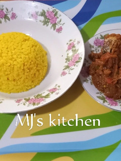 A picture of Turmeric rice and fish sauce.