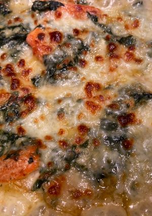A picture of Potato with spinach and cheese.