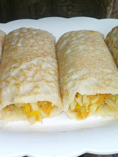 A picture of Crepes with veggies fillings.