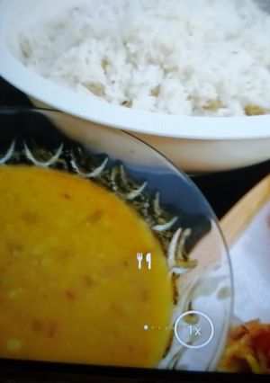 A picture of Boiled rice with daal and fries.
