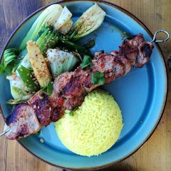 Asian style pork kebabs, steamed veg and yellow rice A picture of Asian style pork kebabs, steamed veg and yellow rice.