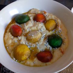 A picture of Colourful rasgulla in custard.