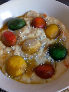 A picture of Colourful rasgulla in custard.