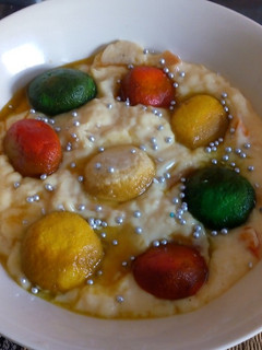 A picture of Colourful rasgulla in custard.