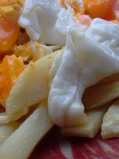 Una foto de Huevos rotos con jamón de bellota y aceite de trufa
