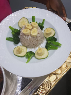 A picture of Ofada rice excited by broccoli, banana and cucumber.