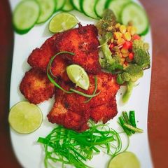 A picture of Hot & crispy frying fish with some Super Green Salad.