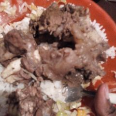 A picture of Beef stew and rice.