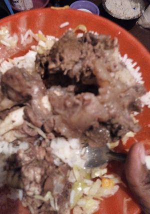 A picture of Beef stew and rice.