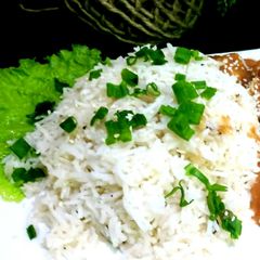 A picture of Garlic rice with sesame chicken.