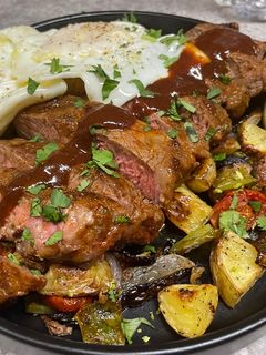 A picture of Chipotle BBQ NY Strip and Fried Eggs.