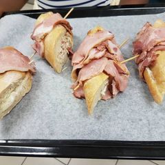 A picture of Bacon baguete stuffed with chicken and vanilla milk.