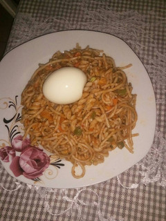 A picture of Jollof spaghetti with macaroni with mixed vegetable.