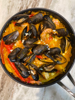 A picture of Shakshuka with Shrimp and Mussels.