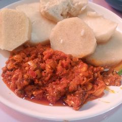 A picture of Boiled yam and palm oil stew.