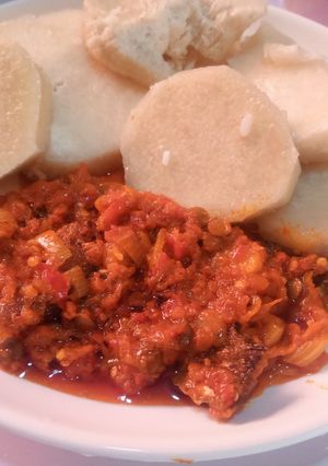 A picture of Boiled yam and palm oil stew.