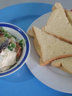 A picture of Bread with sardine,egg,vegetables and mayonise.