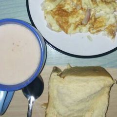 A picture of Fried egg with bread and tea.