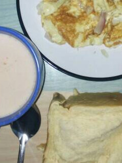 A picture of Fried egg with bread and tea.