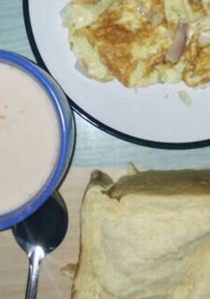 A picture of Fried egg with bread and tea.