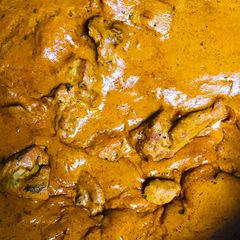 A picture of Gravy chicken with splash of charoli seeds.