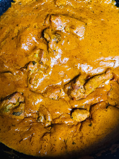 A picture of Gravy chicken with splash of charoli seeds.