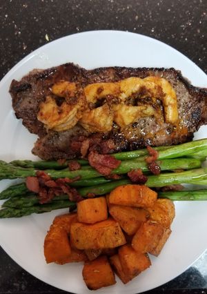 A picture of Cajun Shrimp Steak with Honey Glazed Bacon Asparagus.