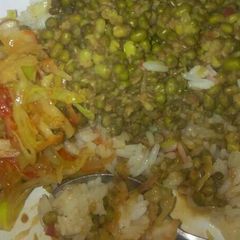 A picture of Rice with green grams and cabbages.