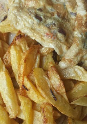 A picture of Chips and fried egg.