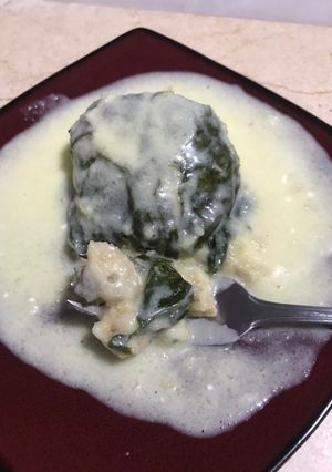 Una foto de Tamales canarios en hoja de acelgas, con crema de piña