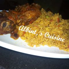 A picture of Jollof rice with peppered chicken.