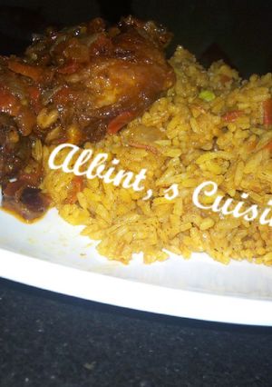 A picture of Jollof rice with peppered chicken.