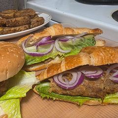 A picture of Shami kabab croissant sandwich.