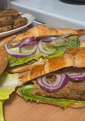 A picture of Shami kabab croissant sandwich.