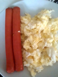 A picture of scrambled egg & sausages.
