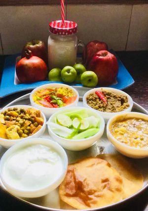 A picture of Ridge gourd Sabzi,Lauki-Channadal,MixedVeg,Curd,Dry Moong dal,Pooris,Fruits.