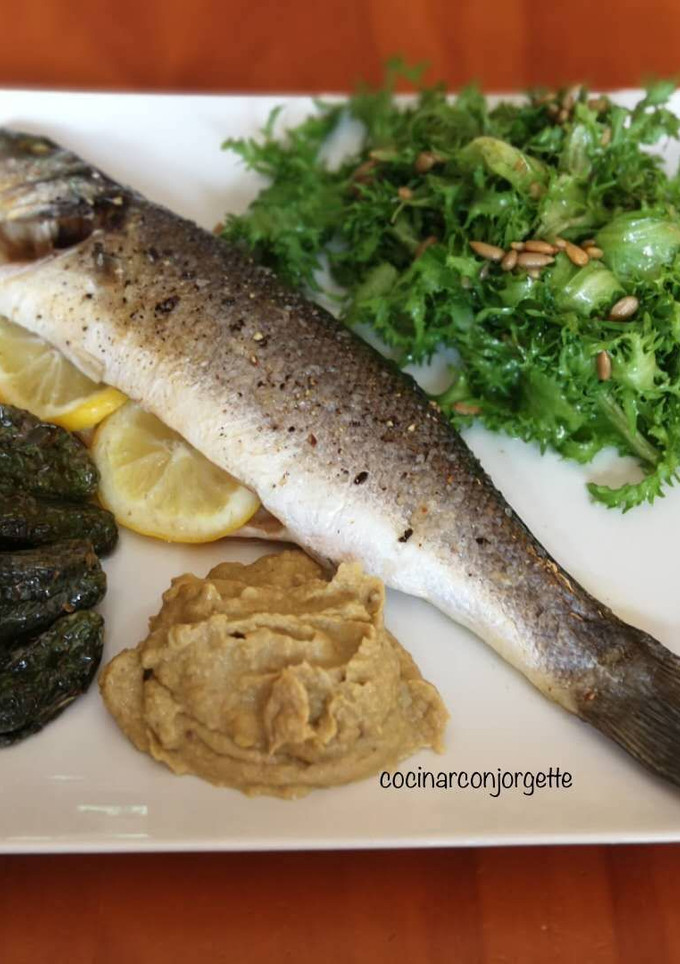 Una foto de Lobarro al horno con hummus y ensalada