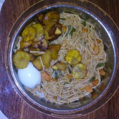 Spagetti with fried plantain,egg and vegetable A picture of Spagetti with fried plantain,egg and vegetable.