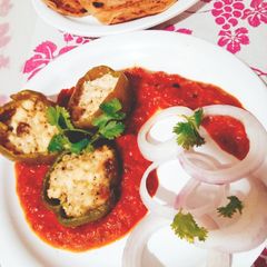 A picture of Punjabi Paneer stuffed Capsicum in Red Gravy.