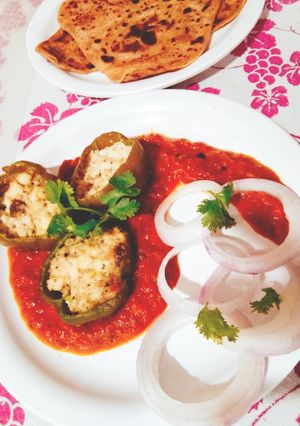 A picture of Punjabi Paneer stuffed Capsicum in Red Gravy.