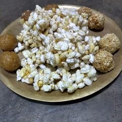 A picture of Khoi gur,naru and tiler Nadu(parched rice jaggery mix, coconut and sesame ladoo).