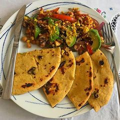 A picture of Chickpeas Raw mango Sundal with Gramflour flat bread.