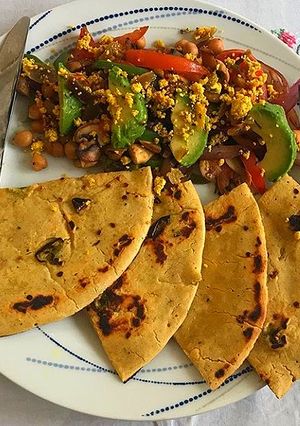 A picture of Chickpeas Raw mango Sundal with Gramflour flat bread.