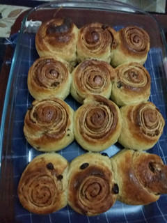 A picture of Cinnamon rolls with raisins.