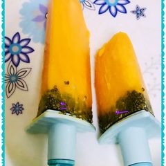 A picture of Tangy orange tang popsicles with chia seeds.